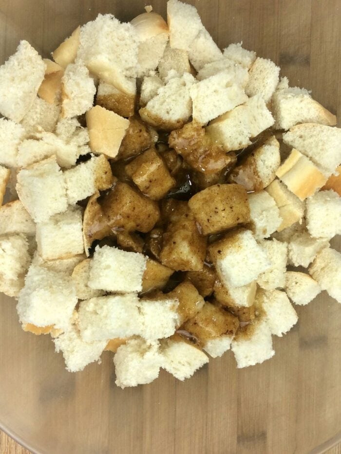 The wet ingredient poured over the cubed French bread