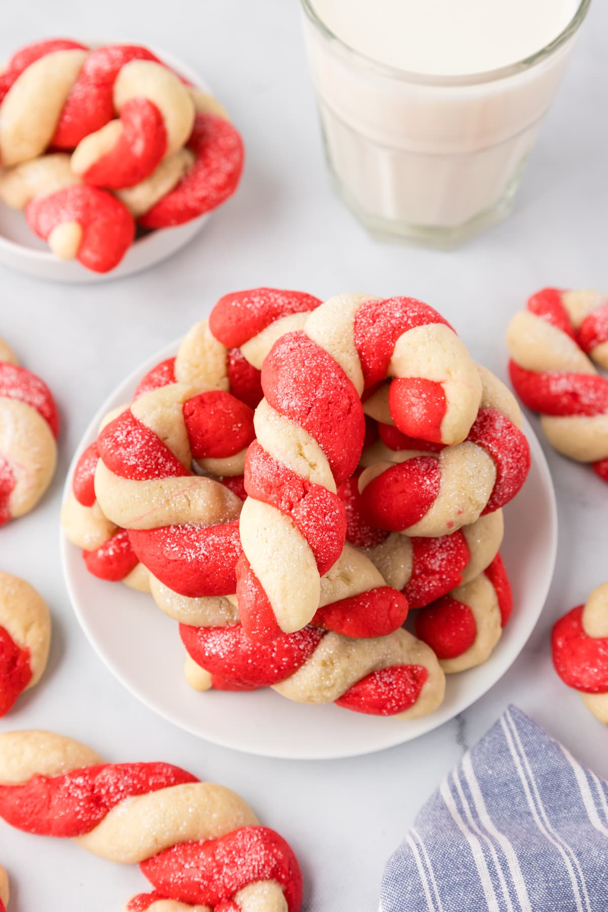 A bunch of Candy Cane Cookies with white milk.