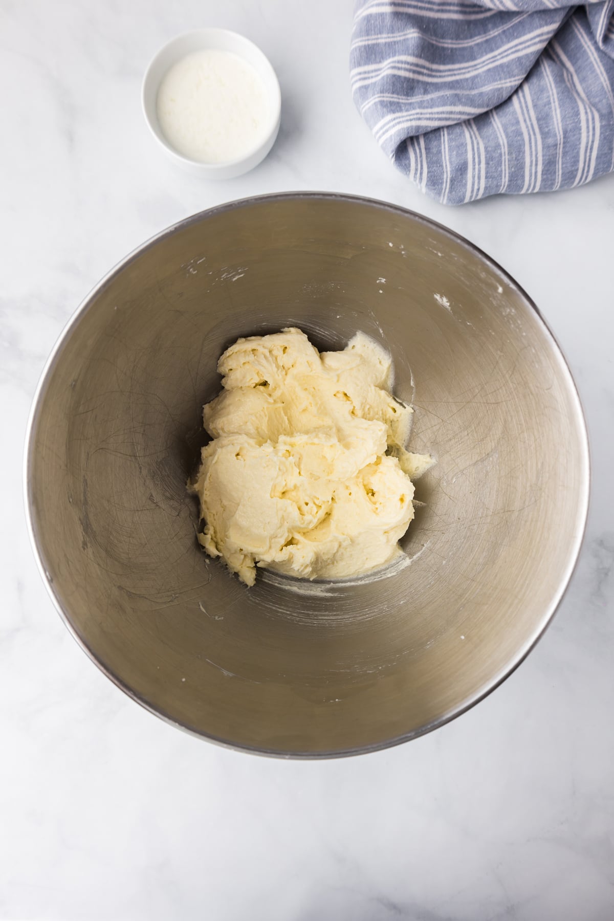 Butter creamed in a silver mixing bowl.