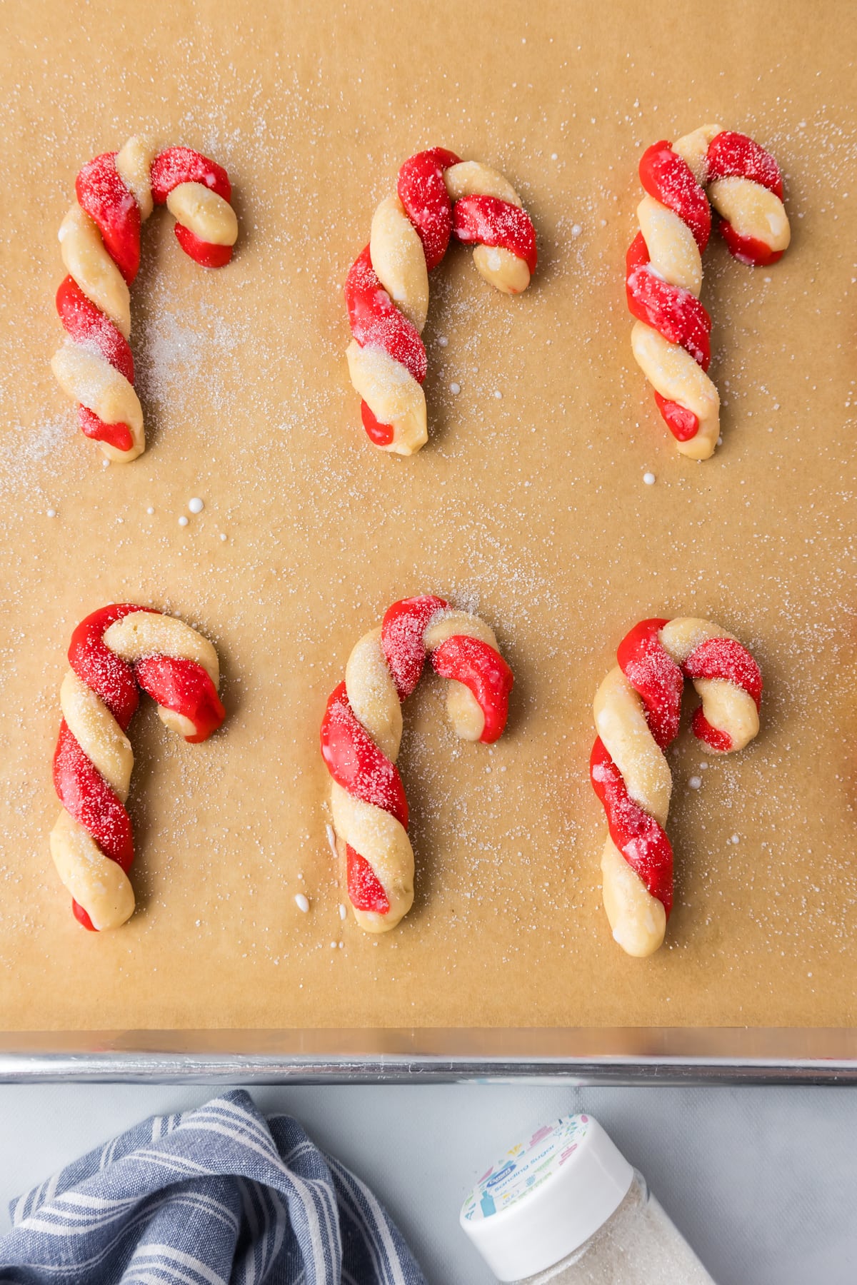 Baked candy cane cookies on parchment paper.