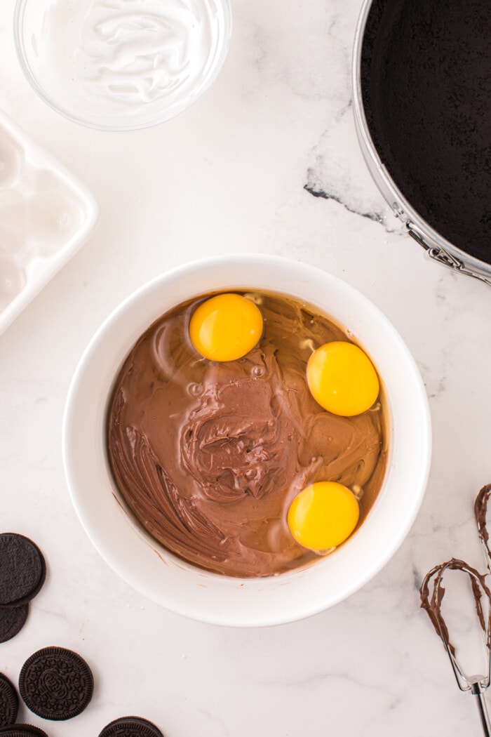 3 eggs added to chocolate cheesecake batter.