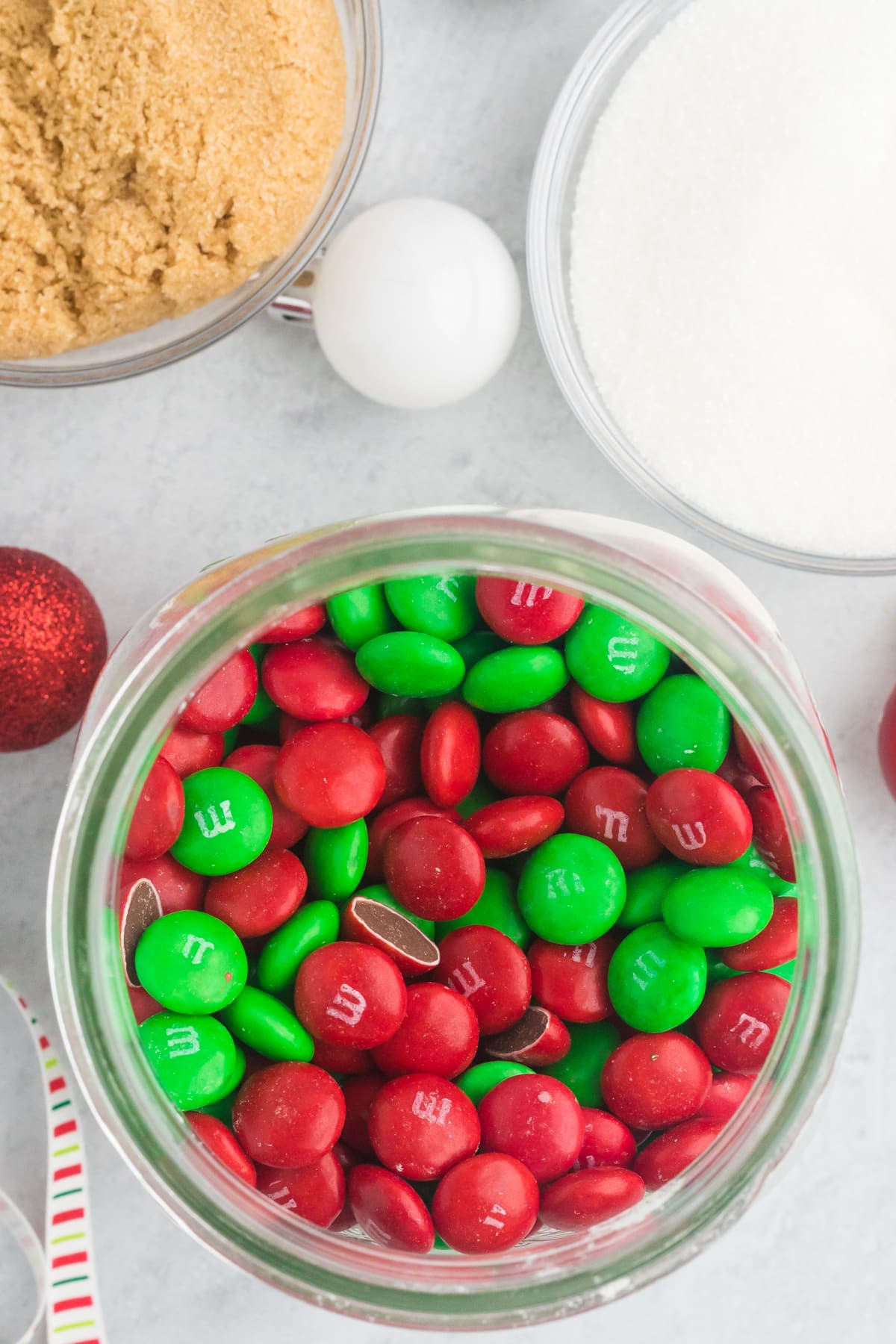 M&M's added to a jar for Christmas Cookies.
