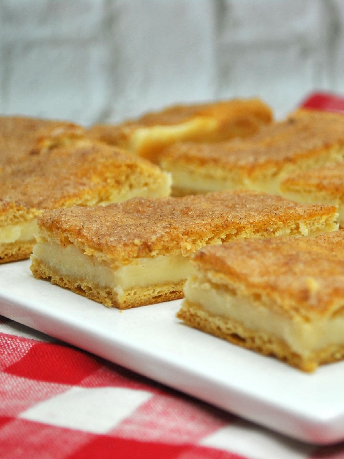 two rows of cheesecake bars cut into squares