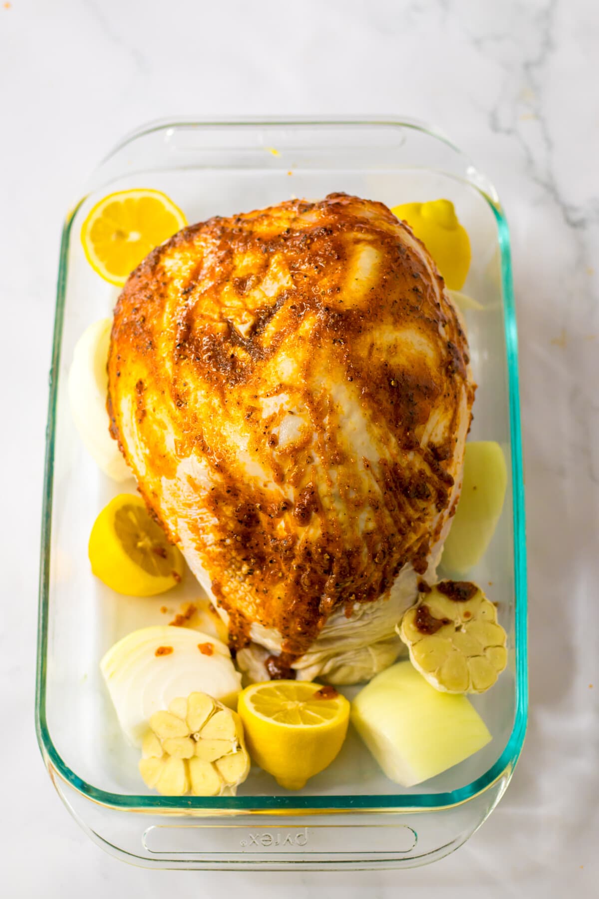 roast turkey breast with aromatics in a baking dish