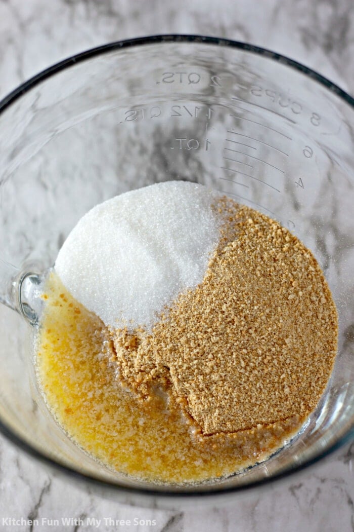 Ingredients for the lemon cheesecake bar crust in a glass mixing bowl