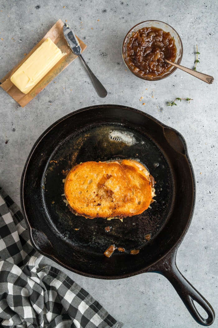 French Onion Grilled Cheese in a black cast iron skillet.