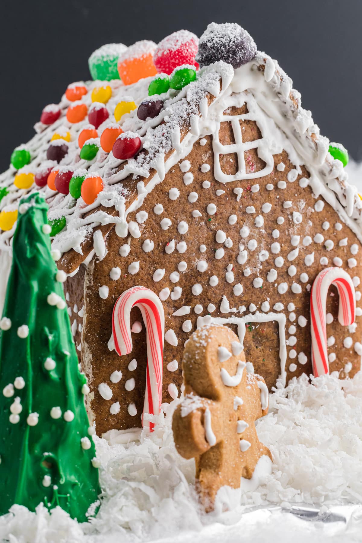 Decorated Gingerbread House with Gingerbread Men and candy canes.