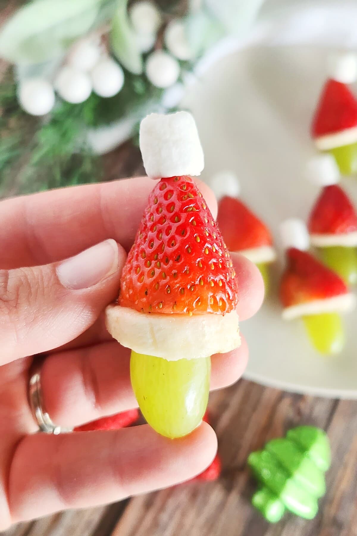 grinch fruit kabob in a hand