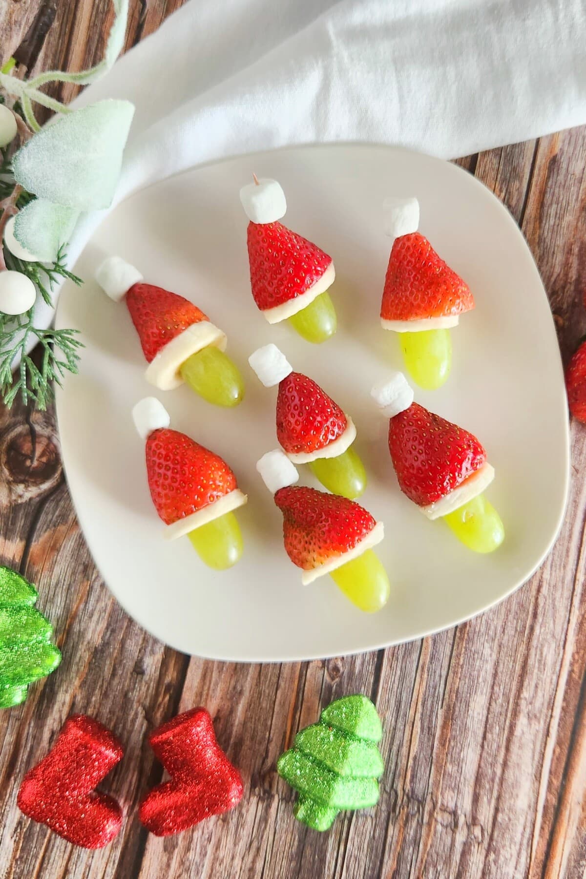 grinch fruit kabob on a white plate