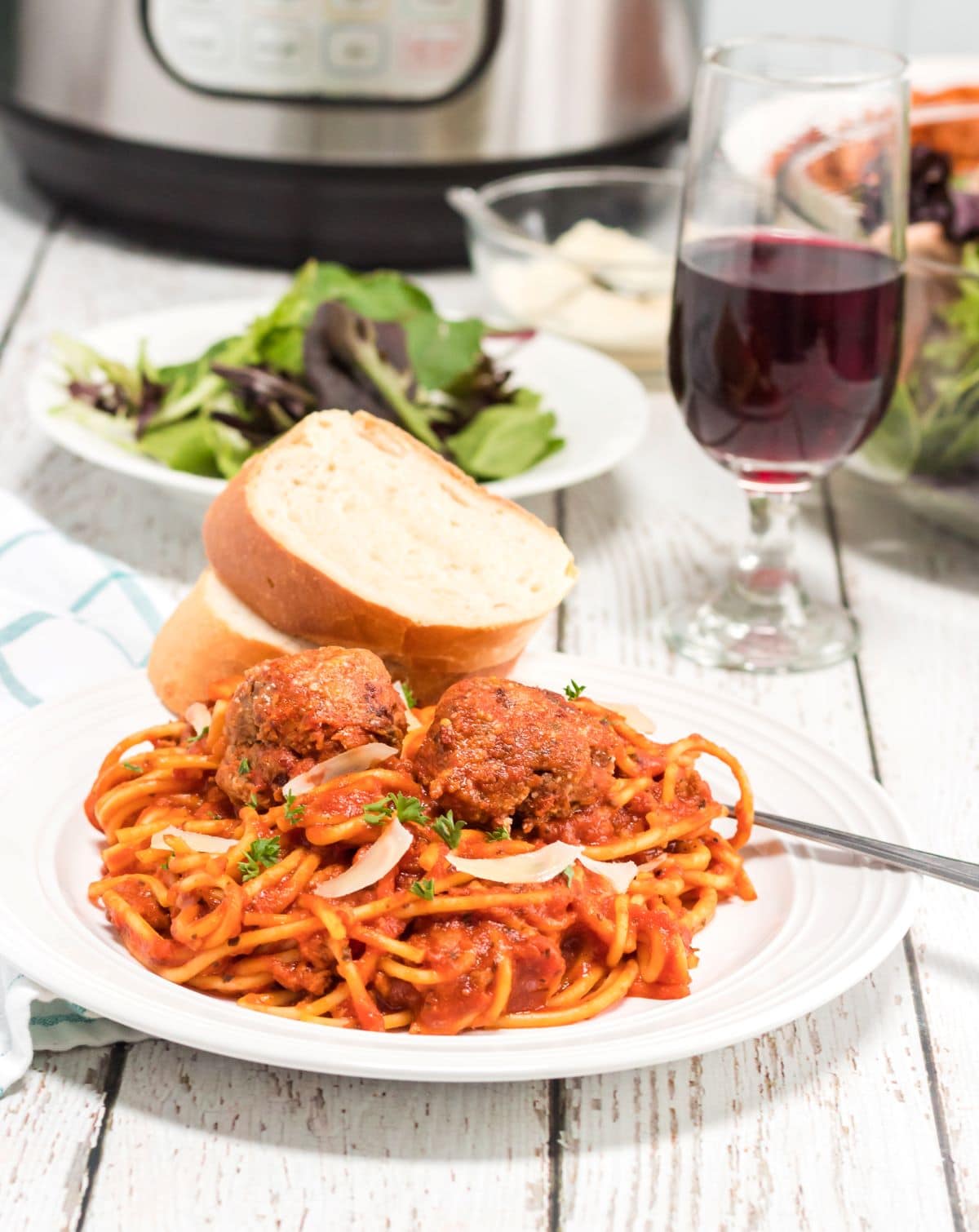 Homemade Spaghetti and Meatballs Recipe with a side of Italian bread.