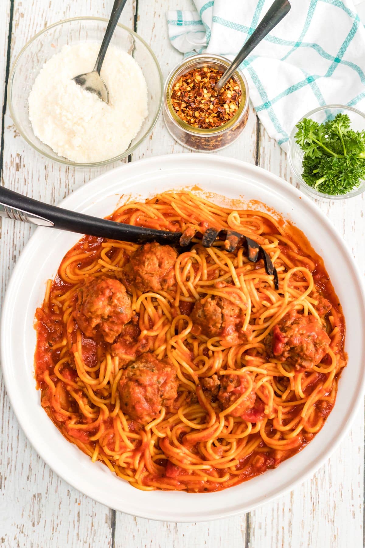Homemade Spaghetti and Meatballs Recipe in a serving bowl with a spoon.