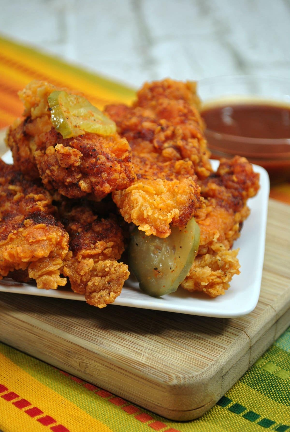 Nashville Chicken with Pickles on a white plate