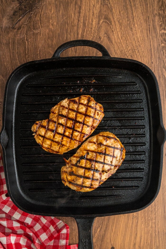 Two chicken breasts on a grill pan
