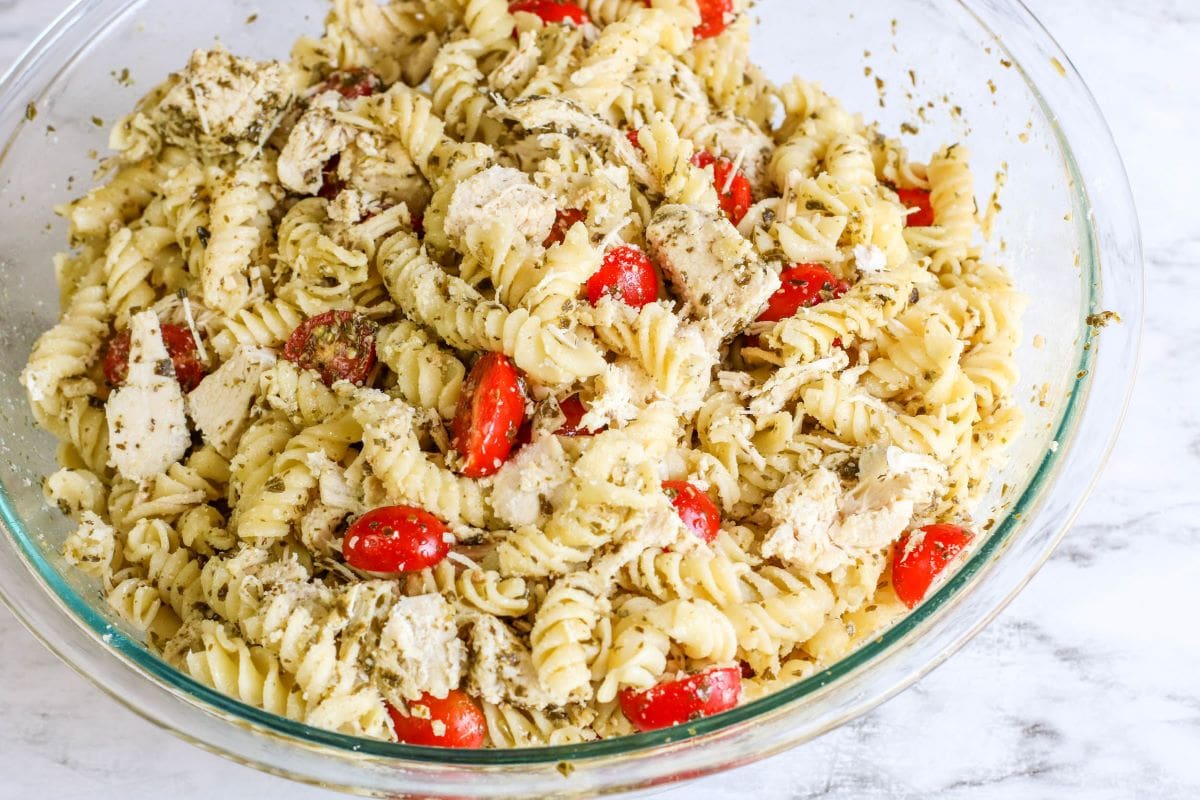 Chicken Pesto Pasta with Tomatoes in a white bowl