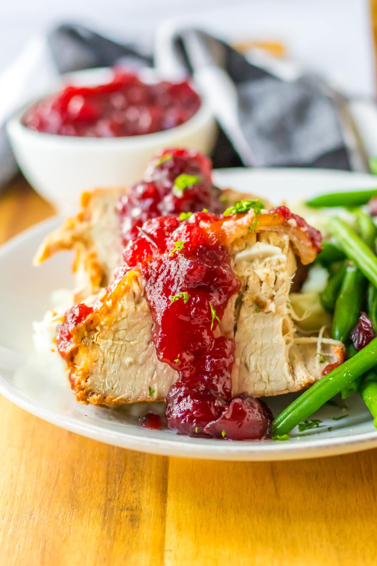 slow cooker cranberry pork loin on a white plate