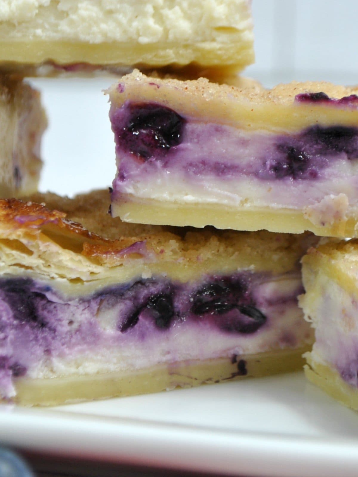 Close up of Sopapilla Blueberry Cheesecake Bars on a plate