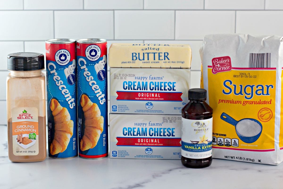 ingredients to make sopapilla cheesecake on a marble countertop.