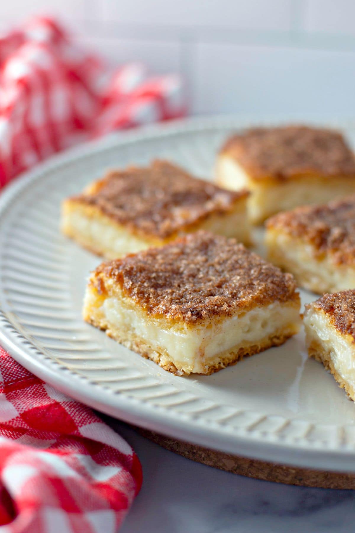cut squares of Easy Sopapilla Cheesecake Recipe on a plate