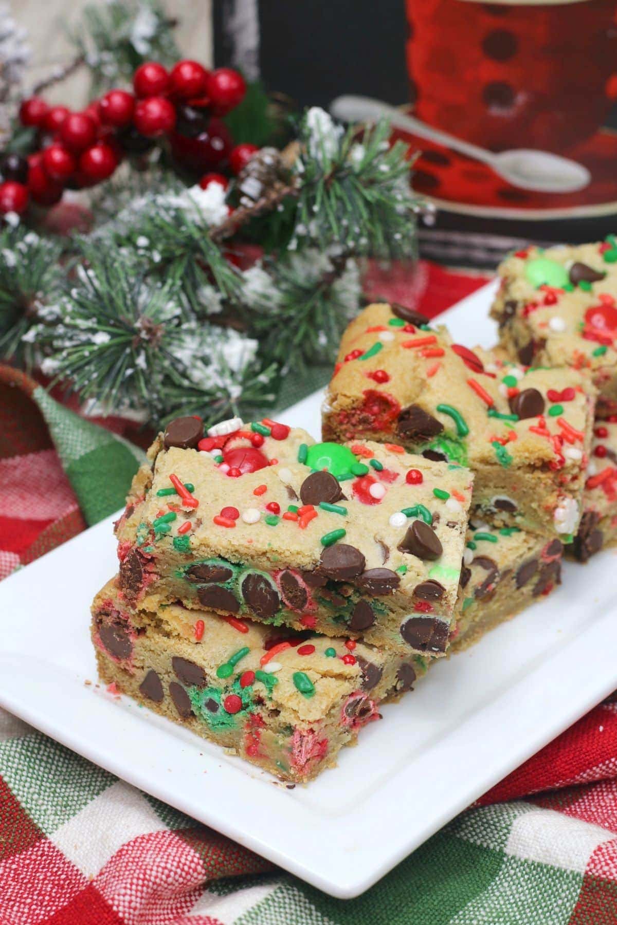 Christmas Cookie Bars with snow frosted decorations next to it.