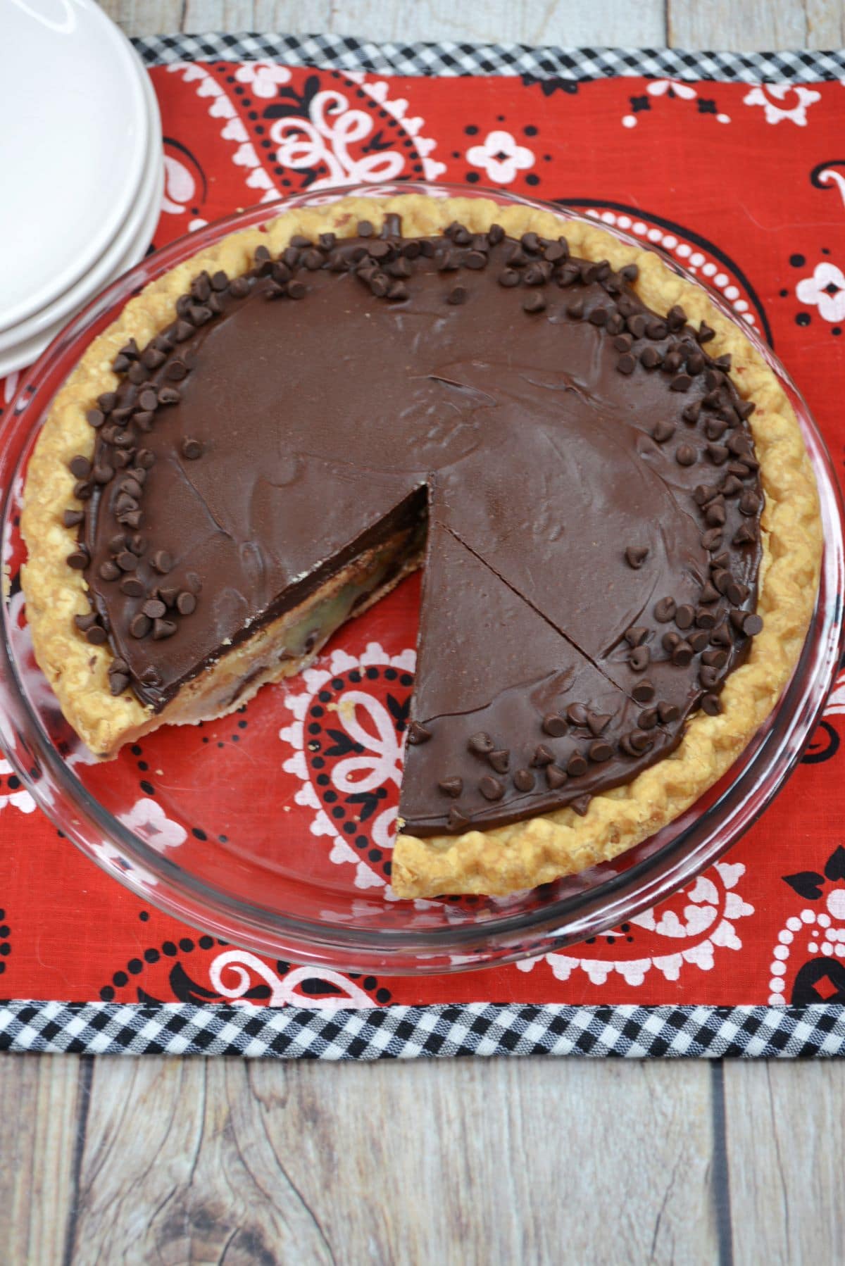 Kentucky derby pie on a pie plate on a red, white and black table cloth