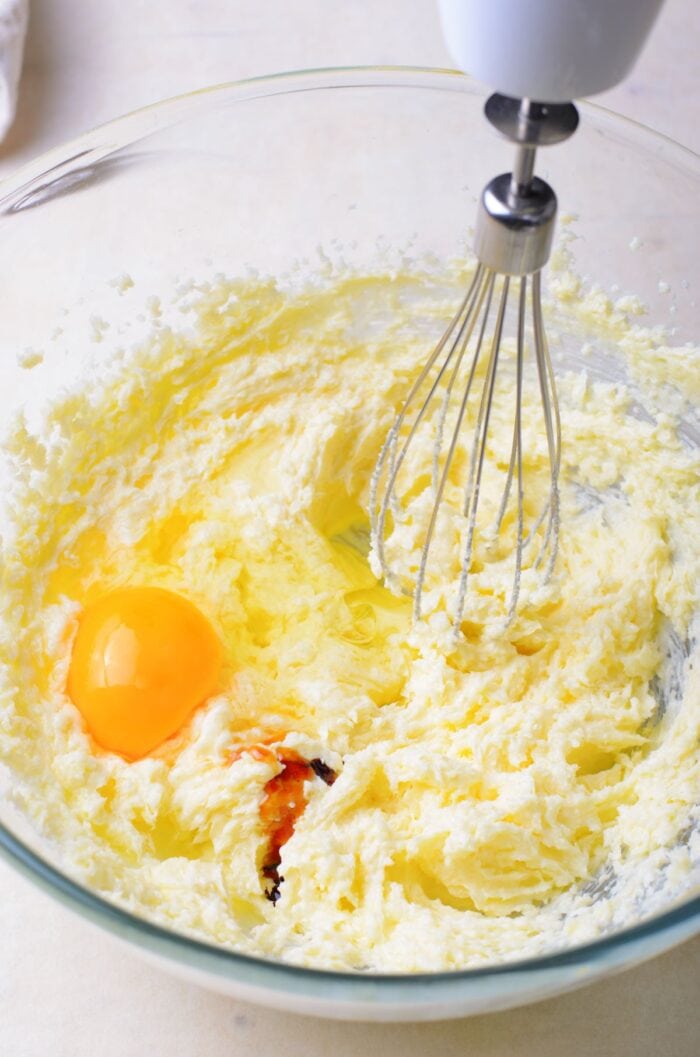 Creaming butter and sugar together and adding in eggs and vanilla