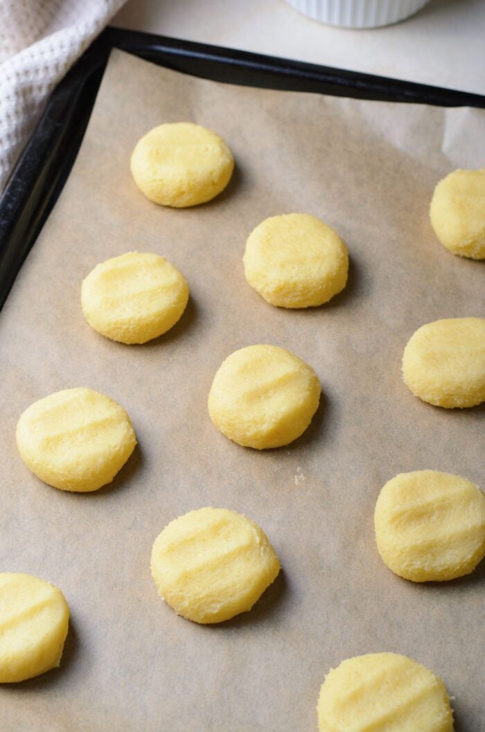 Vanilla Meltaway Cookies on parchment paper on a baking sheet