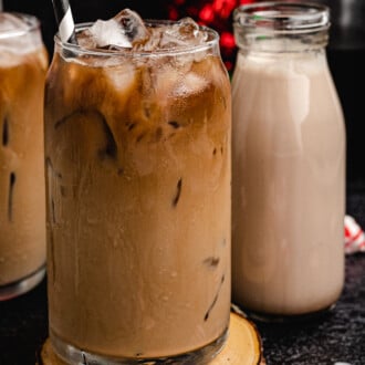 Peppermint Mocha Coffee Creamer in iced coffee with a glass jar in the back