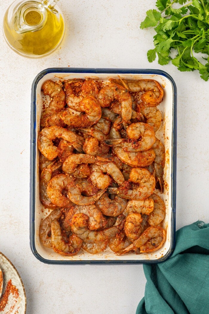 Seasoned uncooked shrimp in tray