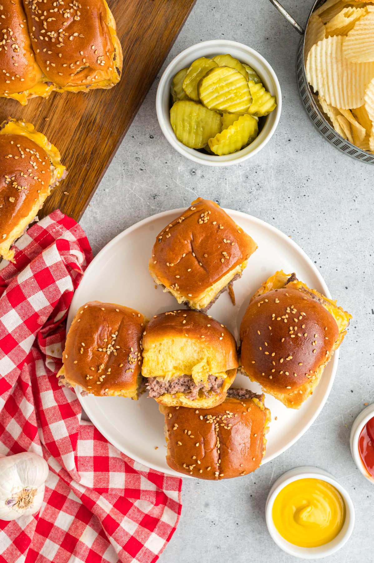 Cheeseburger sliders on a white plate.