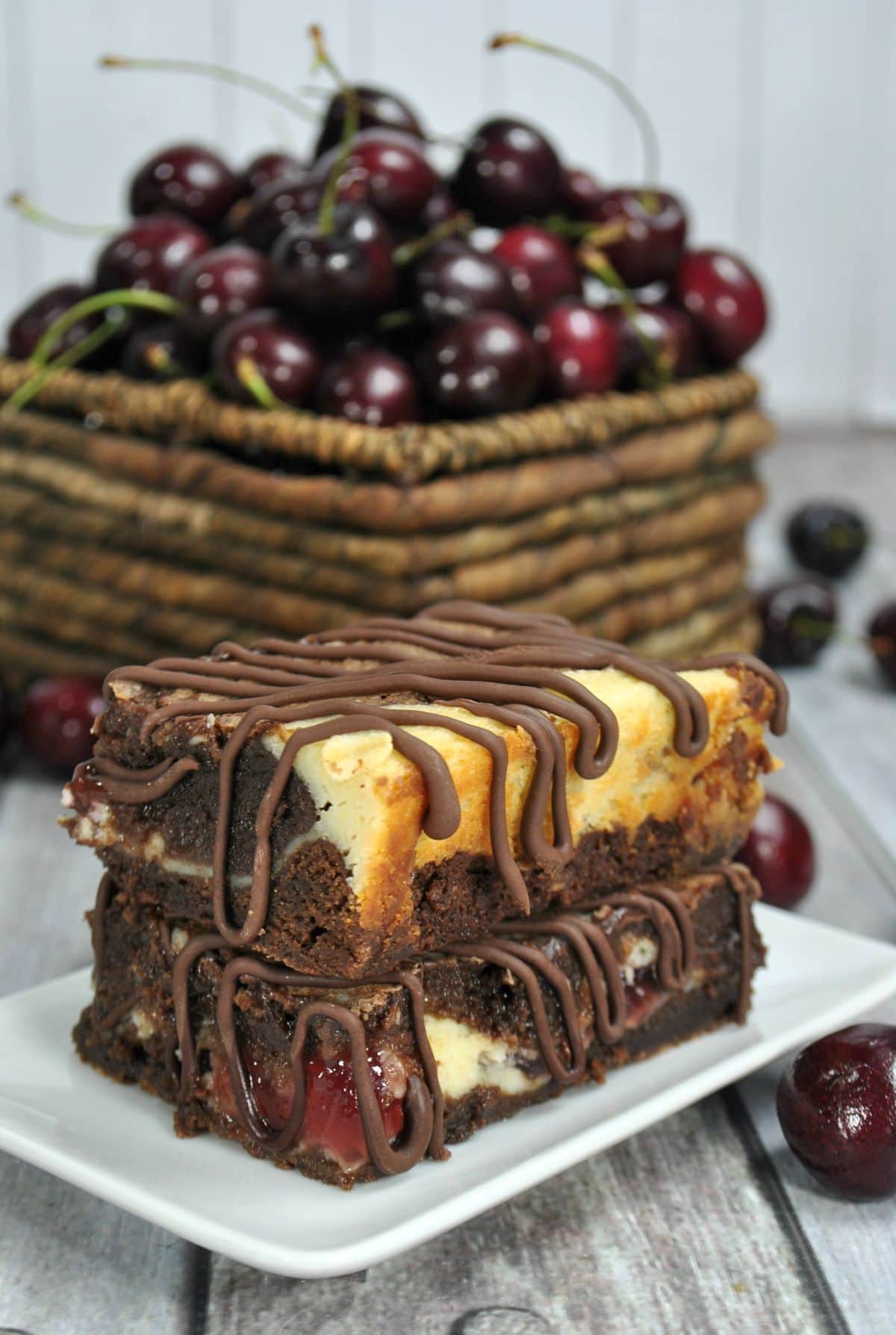Cherry Pie Brownie Cheesecake Bars on a plate