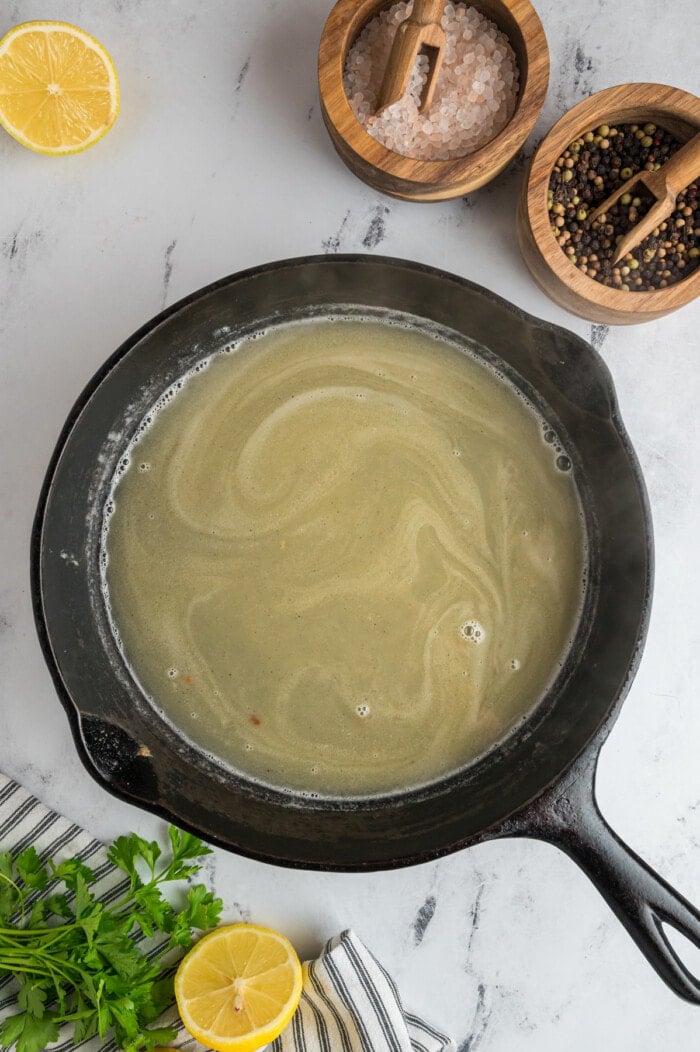 Broth and white wine in a skillet