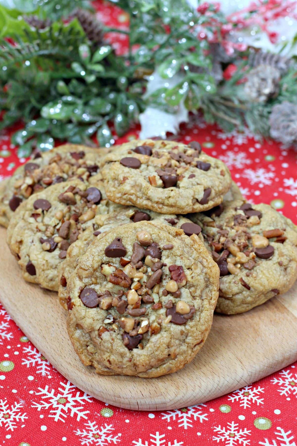 Chocolate Chip Toffee Pecan Cookies on a wooden board.