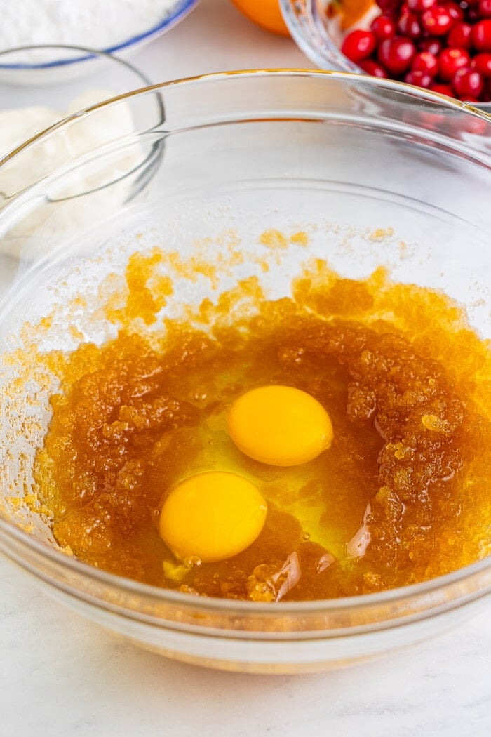 Eggs, brown sugar and butter in a bowl for muffins.