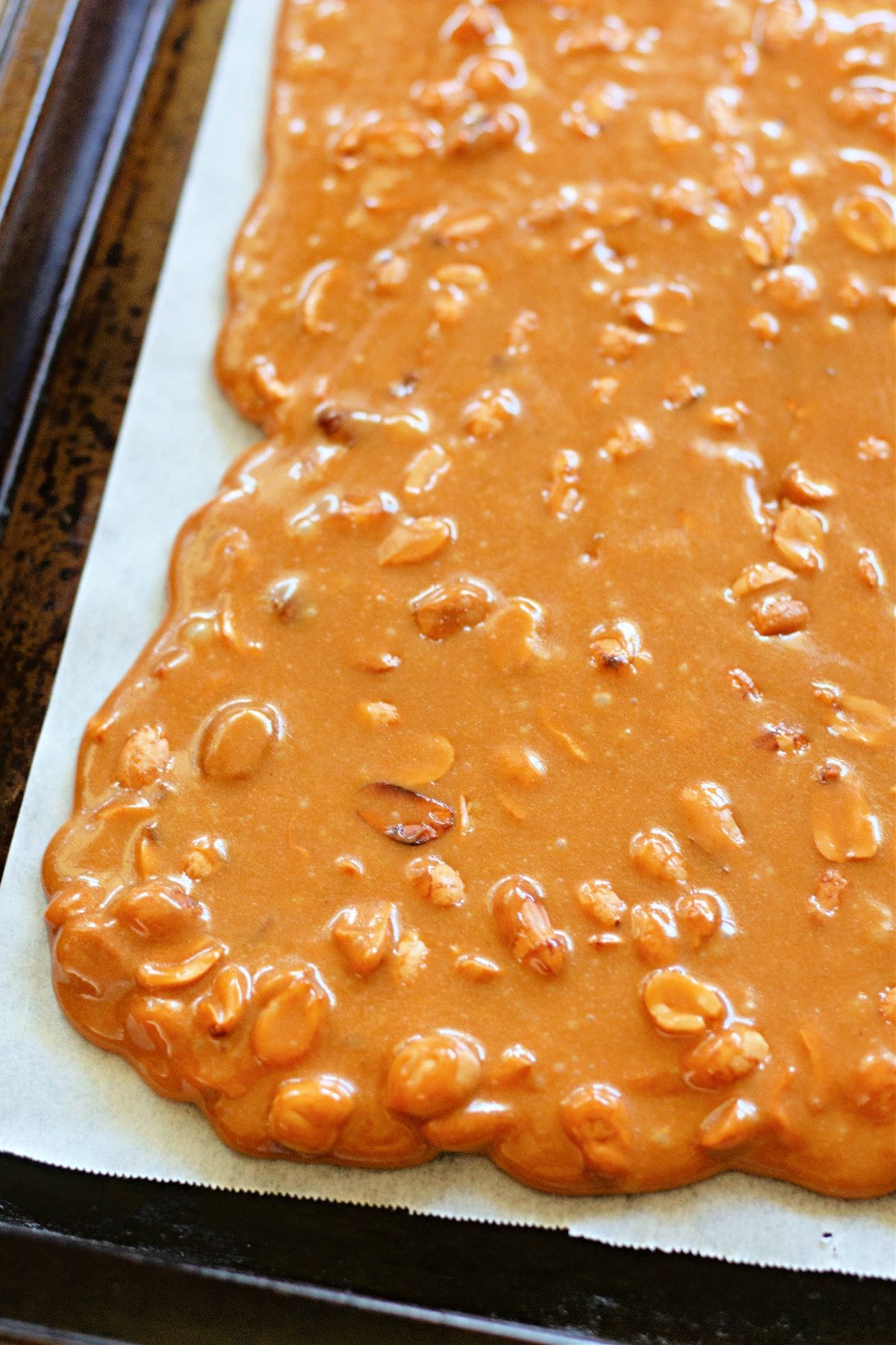 the peanut brittle cooling on parchment paper