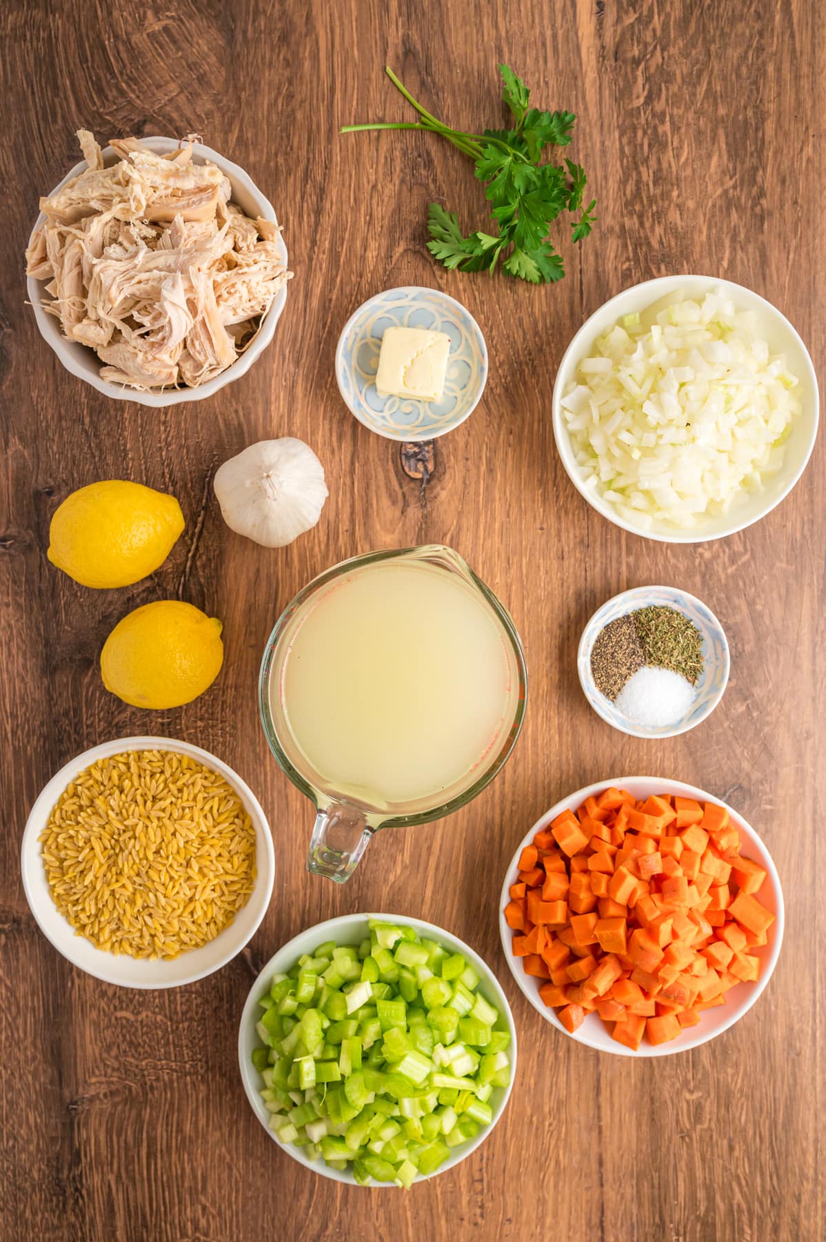 Overhead view of ingredients for lemon chicken orzo soup