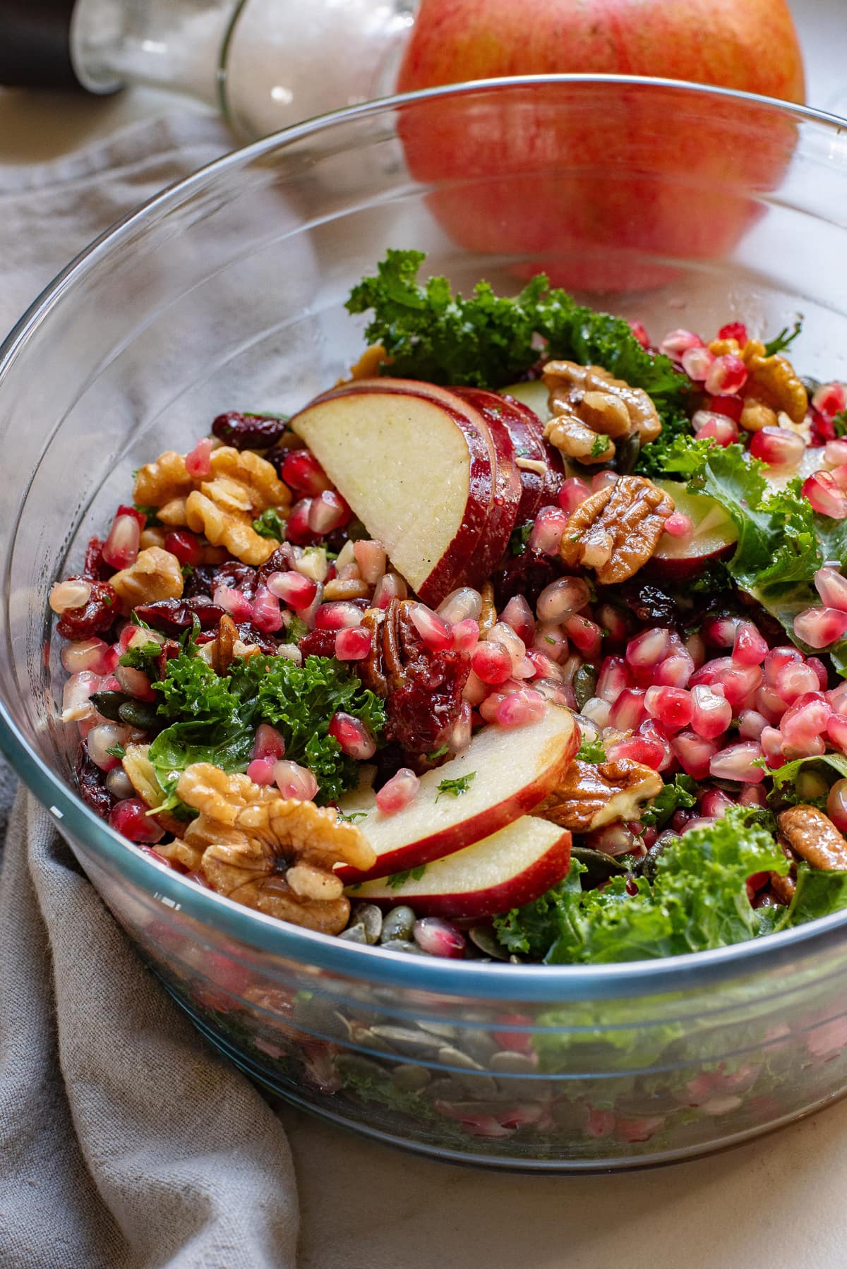 Pomegranate salad in a clear bowl.