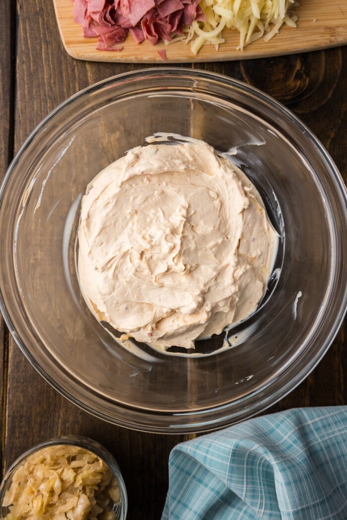 Blended cream cheese in a glass bowl 