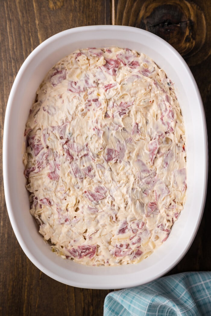 Reuben Dip in a casserole dish ready to be baked in an oven.