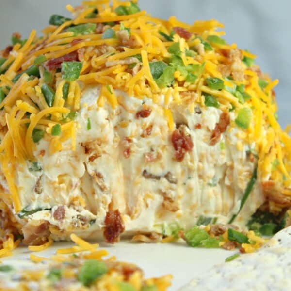 jalapeno popper cheese ball with crackers on a plate