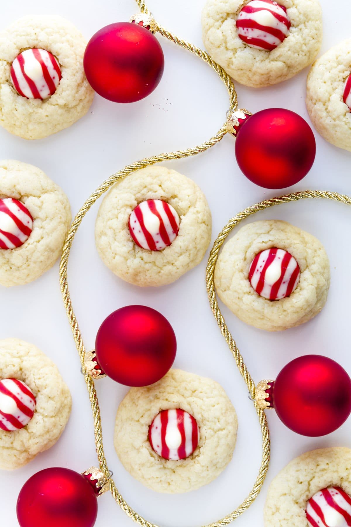 peppermint kiss cookies with ornaments on a gold rope