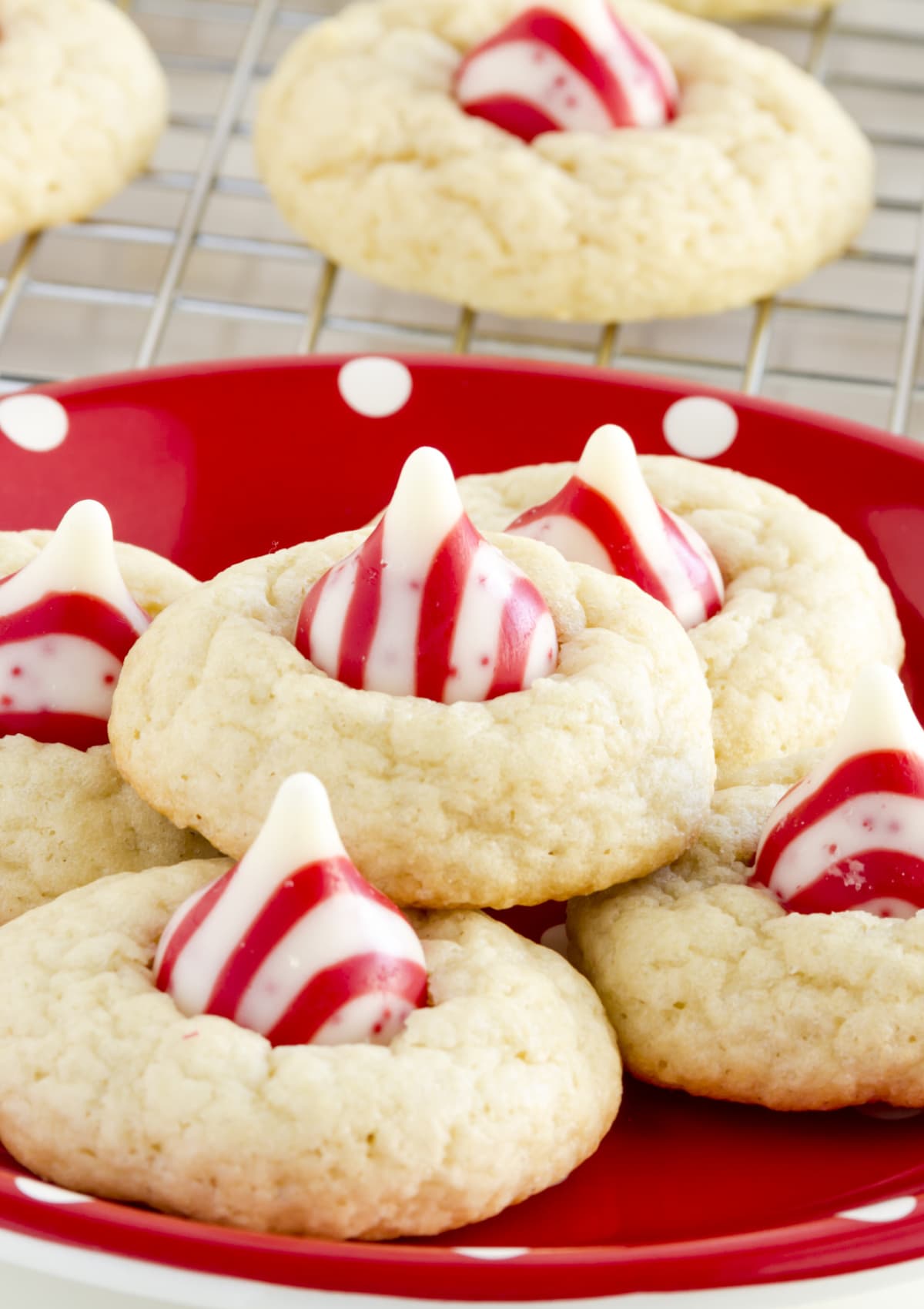 Peppermint Kiss Cookies stacked on a red plate