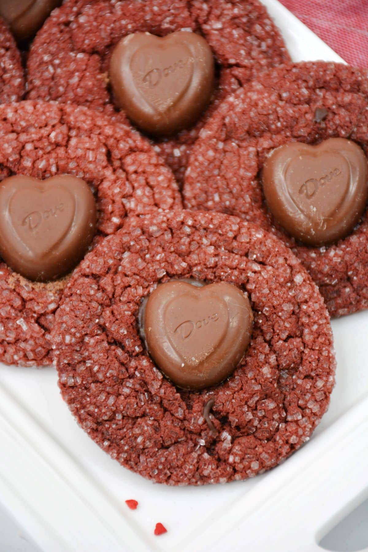 Red Velvet Cookies with chocolate hearts in the middle on a white platter