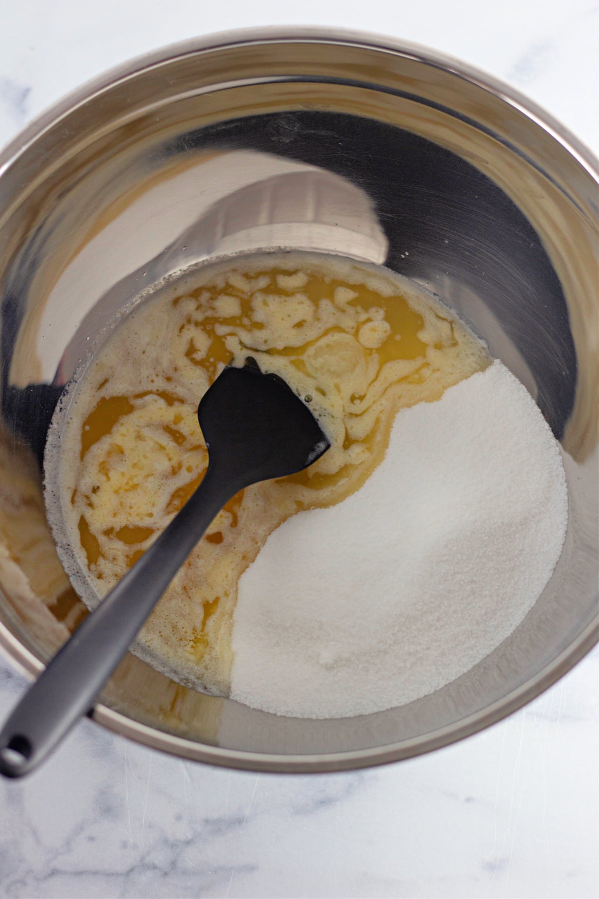 sugar and melted butter in mixing bowl
