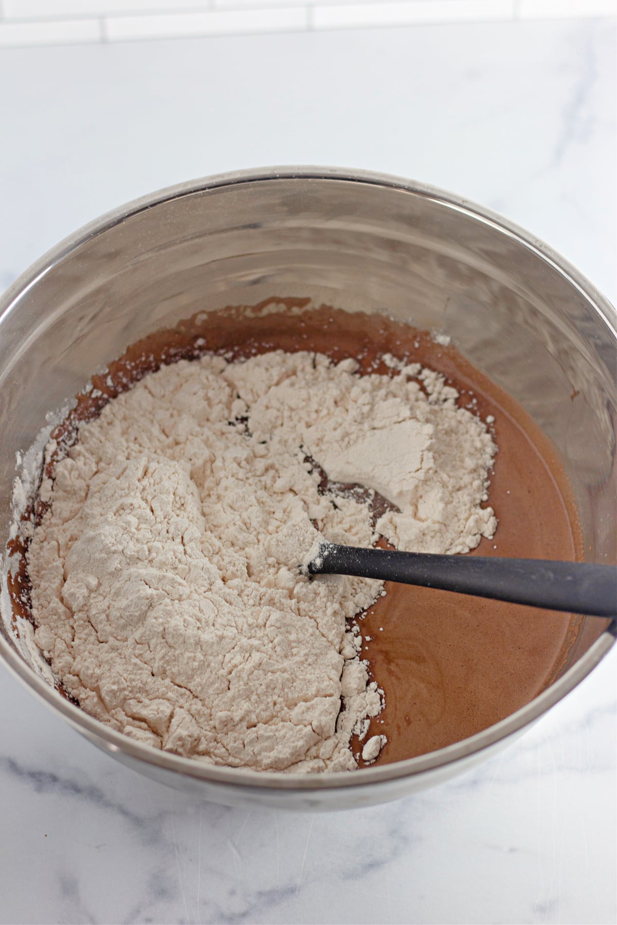dry ingredients in bowl with wet ingredients for chocolate cupcakes
