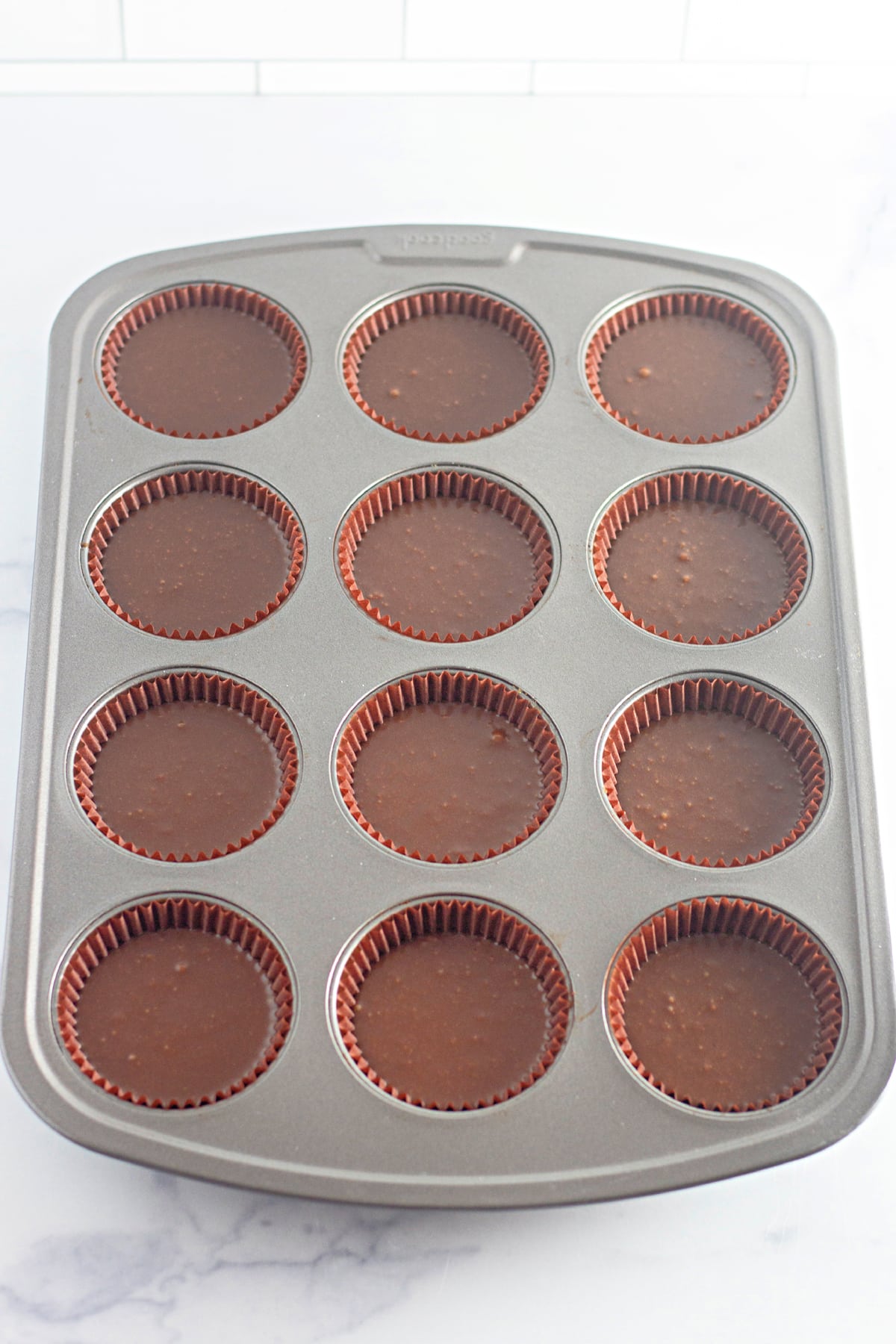 chocolate cupcakes in pan ready to bake