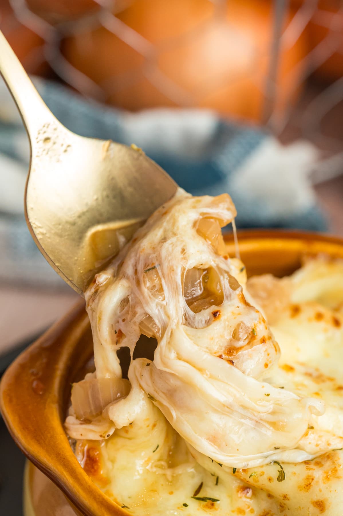 A spoon in a bowl of French onion soup