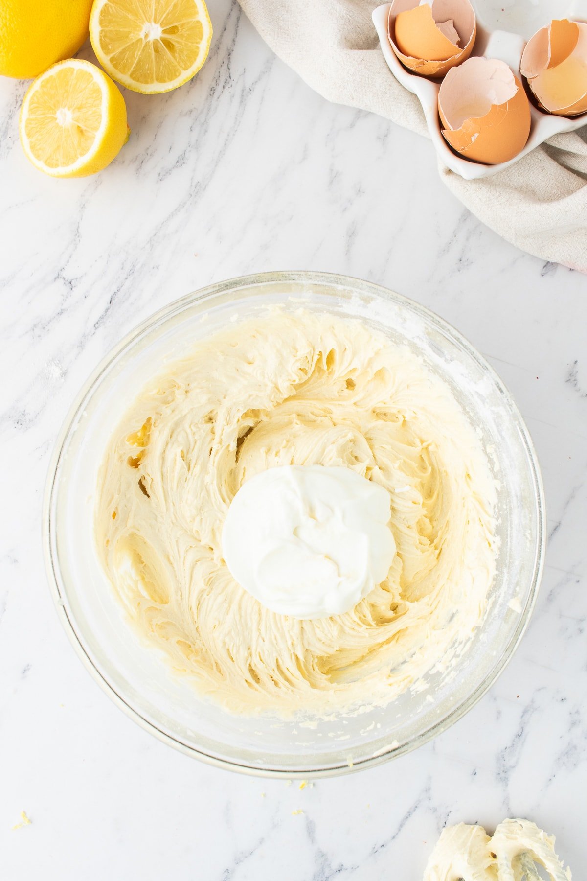 yogurt in mixing bowl with lemon pound cake batter