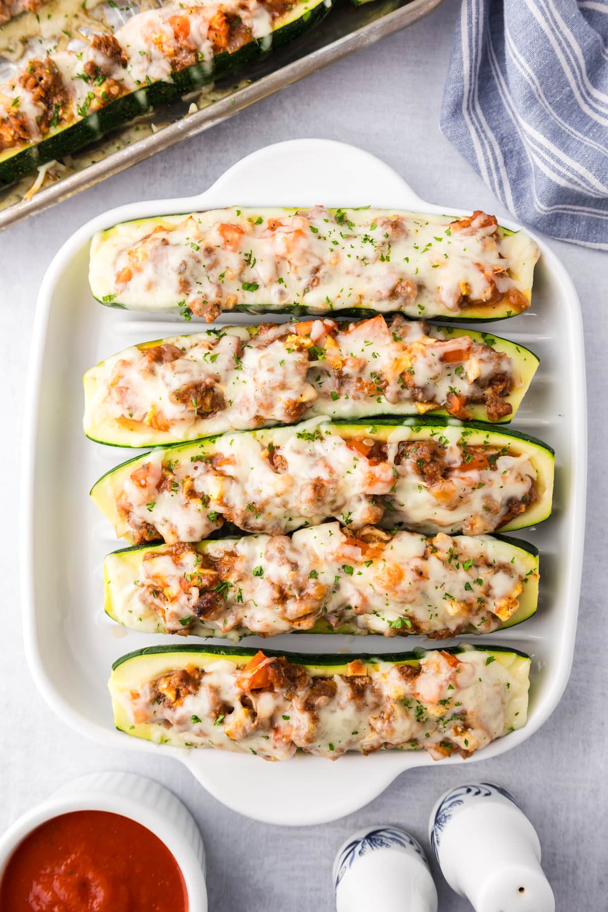 Overhead view of zucchini boats with ground beef on a serving tray