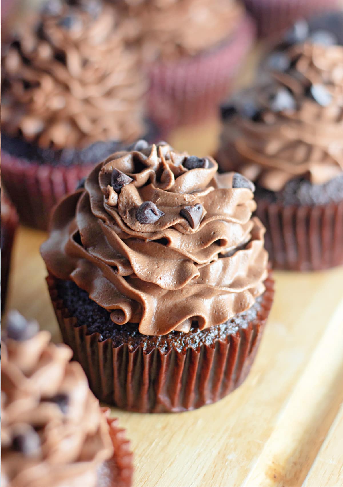 Tops of frosted chocolate cupcakes