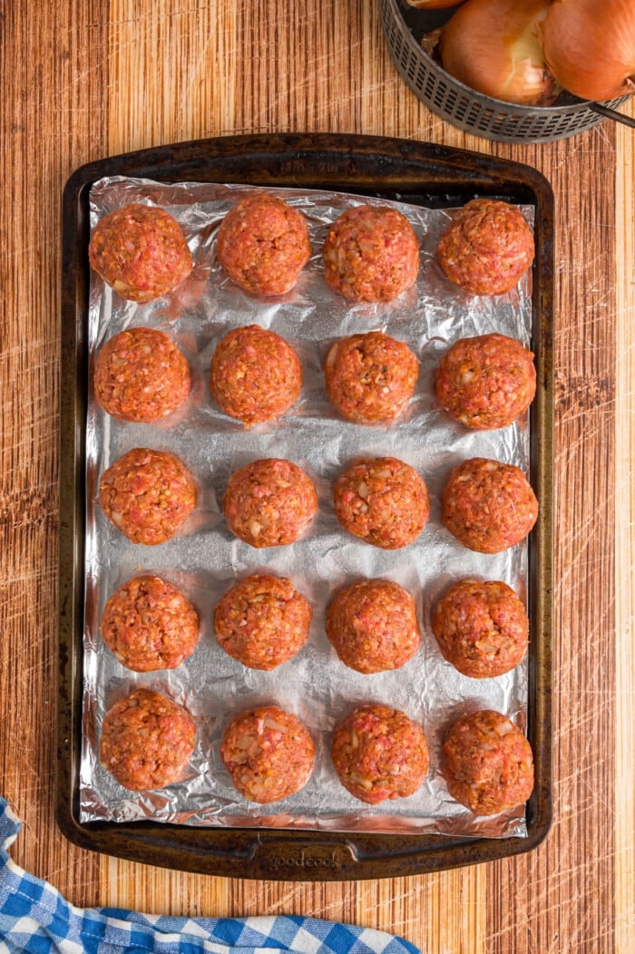 Uncooked meatballs on a baking sheet